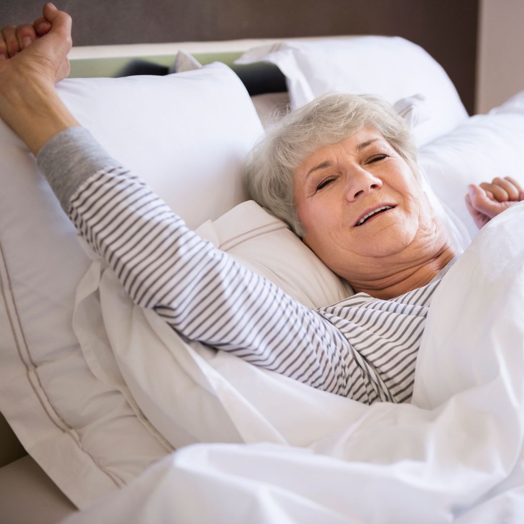 an older adult waking up in bed
