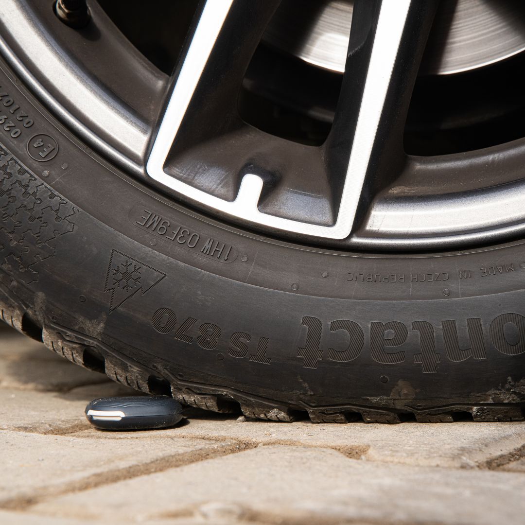 button under a car wheel