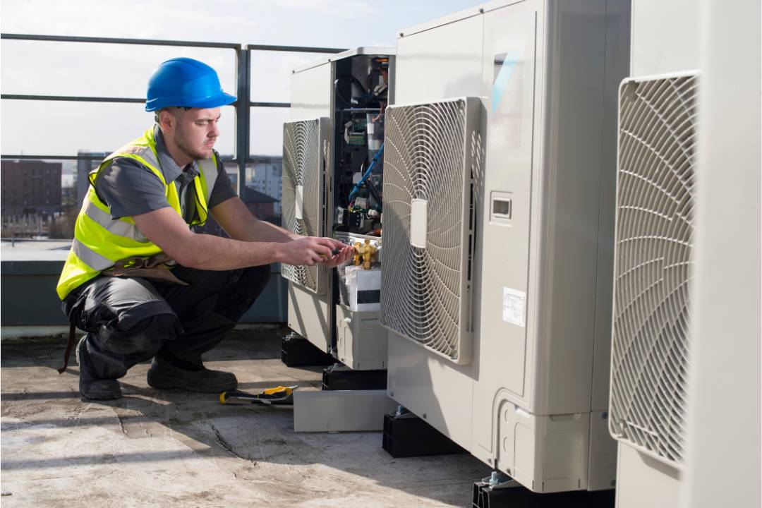 person fixing an air conditioner